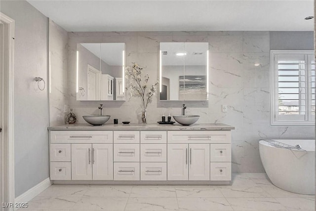 281 Powerbilt Ave, Las Vegas, NV 89148 - full bath featuring marble finish floors, double vanity, a freestanding bath, and baseboards