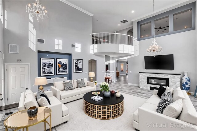 281 Powerbilt Ave, Las Vegas, NV 89148 - living room featuring a chandelier, a towering ceiling, ceiling fan, baseboards, and ornamental molding