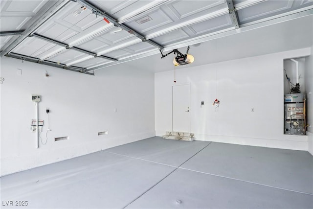 garage featuring secured water heater and a garage door opener