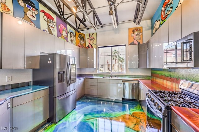 kitchen featuring stainless steel appliances, a sink, and modern cabinets