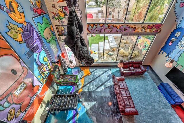 recreation room featuring plenty of natural light, carpet flooring, and baseboards