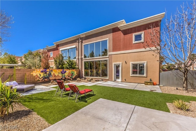 rear view of property featuring a patio area and stucco siding