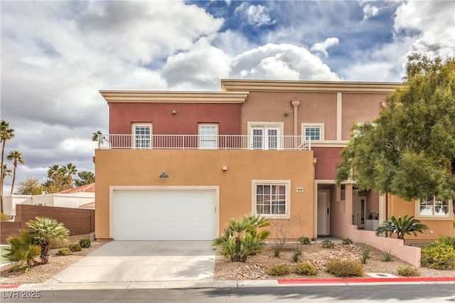 view of front of house featuring stucco siding, a garage, concrete driveway, and fence