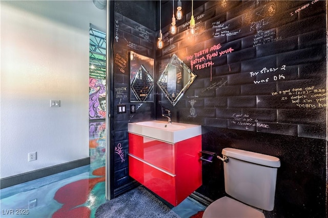 bathroom featuring toilet and vanity