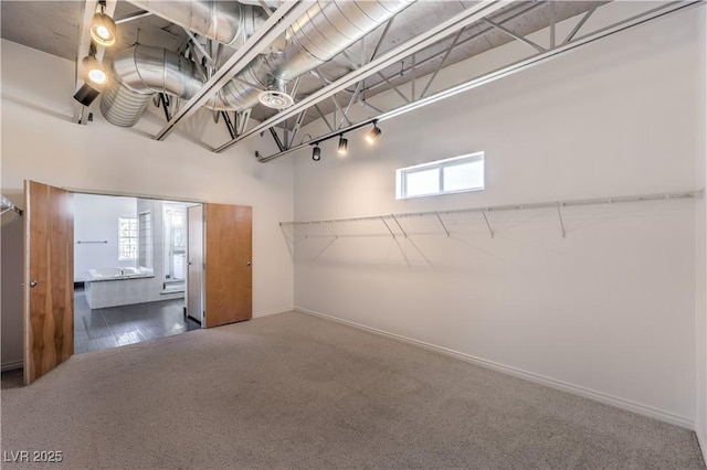 carpeted empty room with baseboards