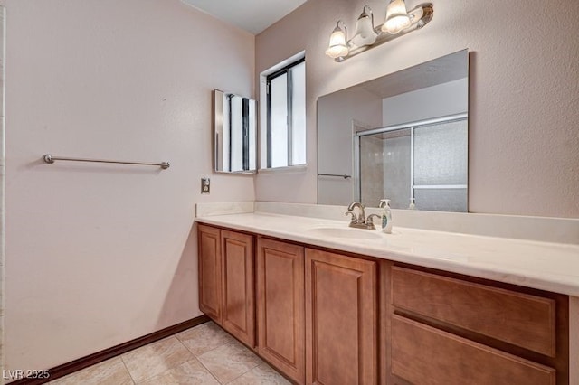 bathroom with a shower stall, vanity, and tile patterned flooring