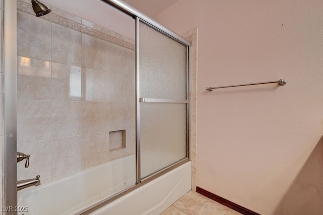 full bathroom featuring bath / shower combo with glass door and tile patterned flooring