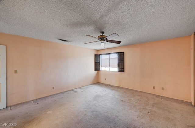 carpeted spare room featuring ceiling fan and a textured ceiling