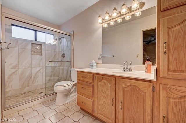 full bath featuring toilet, a shower stall, vanity, and tile patterned flooring