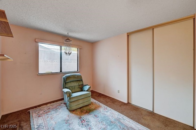 unfurnished room featuring carpet floors and a textured ceiling