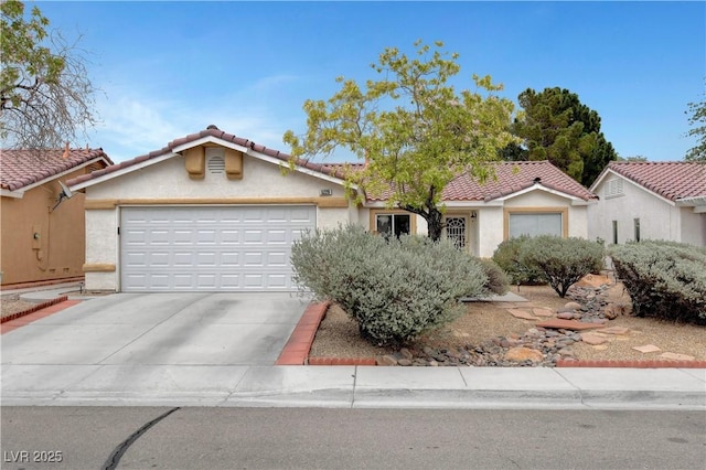 5220 Shasta Daisy St, North Las Vegas, NV 89031 - view of front of property featuring concrete driveway, a garage, stucco siding, and a tiled roof