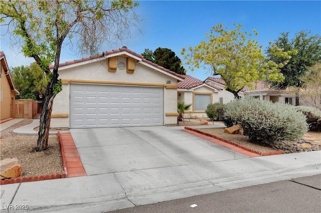 5220 Shasta Daisy St, North Las Vegas, NV 89031 - mediterranean / spanish-style house featuring stucco siding, concrete driveway, a tiled roof, and a garage