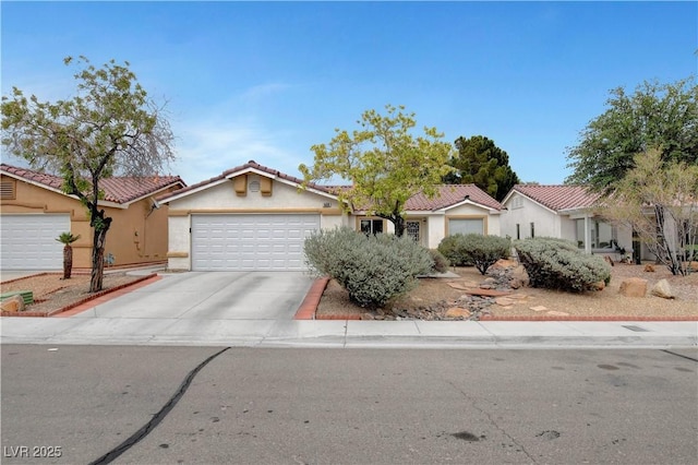 5220 Shasta Daisy St, North Las Vegas, NV 89031 - view of front of home with concrete driveway, a garage, stucco siding, and a tile roof