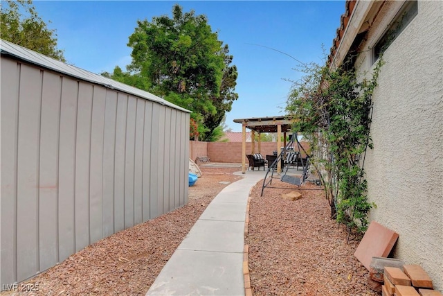 5220 Shasta Daisy St, North Las Vegas, NV 89031 - fenced backyard with a patio area