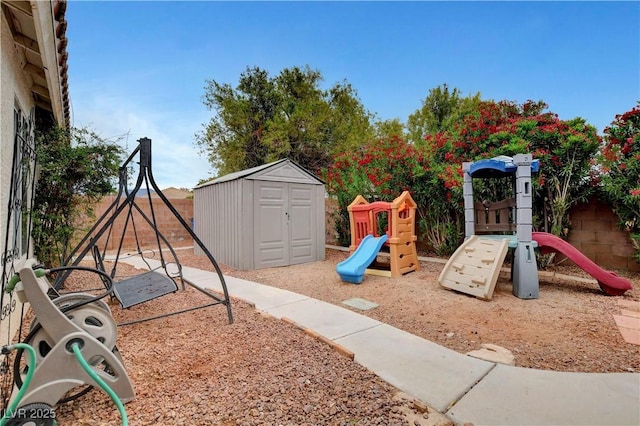 5220 Shasta Daisy St, North Las Vegas, NV 89031 - view of playground featuring a shed, an outdoor structure, and fence