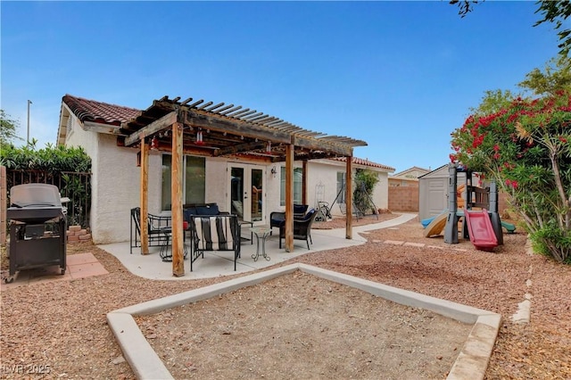 5220 Shasta Daisy St, North Las Vegas, NV 89031 - back of property with a pergola, a storage shed, stucco siding, a fenced backyard, and a patio area