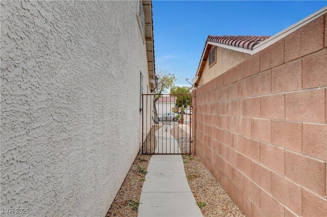 5220 Shasta Daisy St, North Las Vegas, NV 89031 - view of home's exterior featuring stucco siding, a gate, and fence