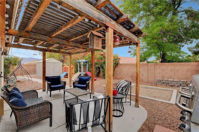 5220 Shasta Daisy St, North Las Vegas, NV 89031 - view of patio featuring a storage shed, a fenced backyard, an outbuilding, and an outdoor hangout area