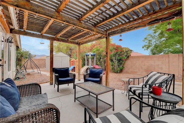 5220 Shasta Daisy St, North Las Vegas, NV 89031 - view of patio featuring a shed, a fenced backyard, an outbuilding, a pergola, and outdoor lounge area