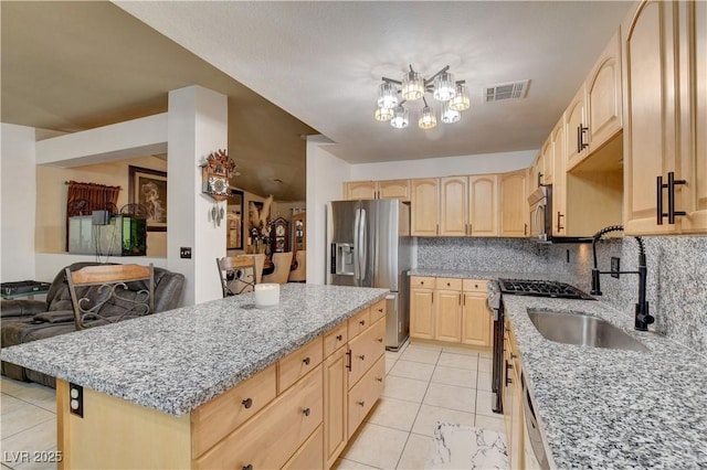 5220 Shasta Daisy St, North Las Vegas, NV 89031 - kitchen featuring light brown cabinets, stainless steel appliances, light tile patterned floors, light stone counters, and a sink