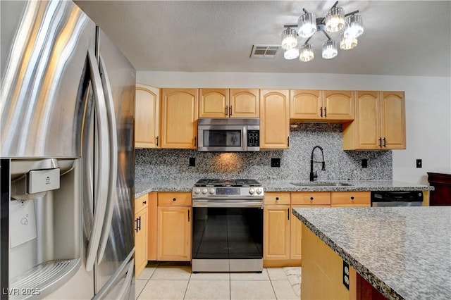 5220 Shasta Daisy St, North Las Vegas, NV 89031 - kitchen with appliances with stainless steel finishes, a sink, light brown cabinets, and light tile patterned floors