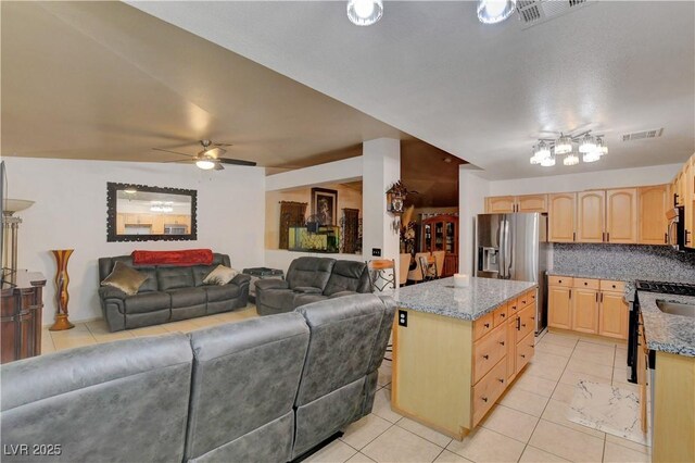 5220 Shasta Daisy St, North Las Vegas, NV 89031 - kitchen with light brown cabinets, open floor plan, and light tile patterned floors