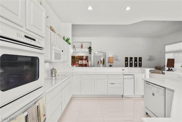 kitchen with white appliances, light countertops, white cabinets, and recessed lighting
