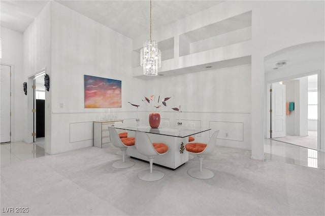 6141 Markleham Ave, Las Vegas, NV 89130 - dining room with a towering ceiling, a chandelier, and a decorative wall