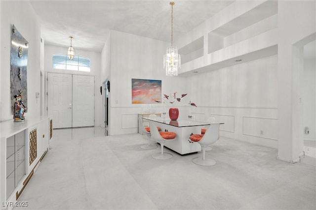 foyer featuring a decorative wall, a chandelier, and carpet
