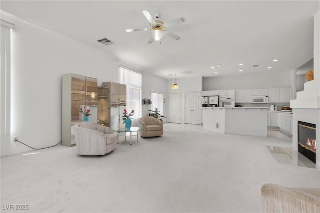 6141 Markleham Ave, Las Vegas, NV 89130 - living room with ceiling fan, light carpet, recessed lighting, and a fireplace