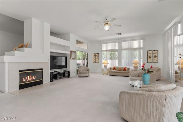 6141 Markleham Ave, Las Vegas, NV 89130 - carpeted living room featuring a ceiling fan and a fireplace