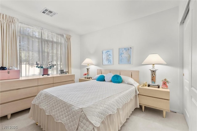 bedroom with light colored carpet