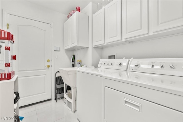 6141 Markleham Ave, Las Vegas, NV 89130 - laundry room with washing machine and dryer, cabinet space, and light tile patterned flooring