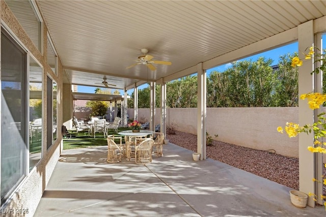 view of patio / terrace featuring outdoor dining area, ceiling fan, and a fenced backyard