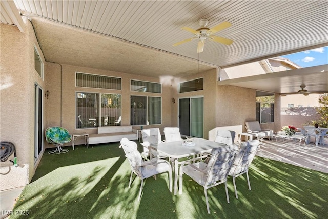 view of patio / terrace with a ceiling fan and outdoor dining space