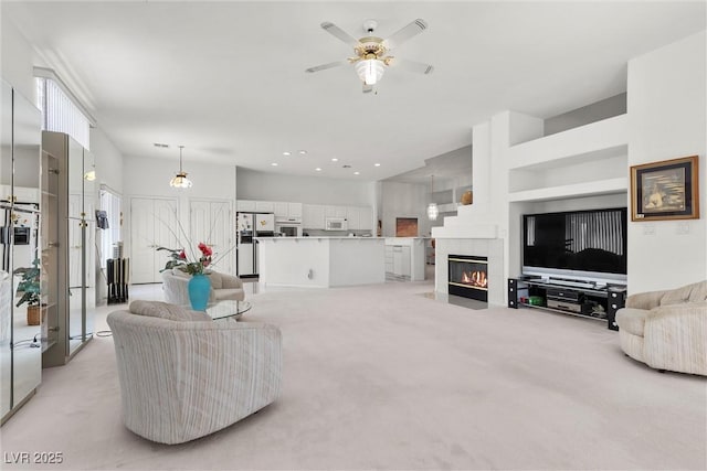 6141 Markleham Ave, Las Vegas, NV 89130 - living room featuring light carpet, ceiling fan, and a tiled fireplace