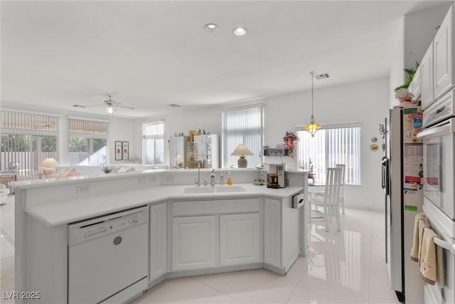 6141 Markleham Ave, Las Vegas, NV 89130 - kitchen featuring white appliances, ceiling fan, white cabinets, light countertops, and recessed lighting
