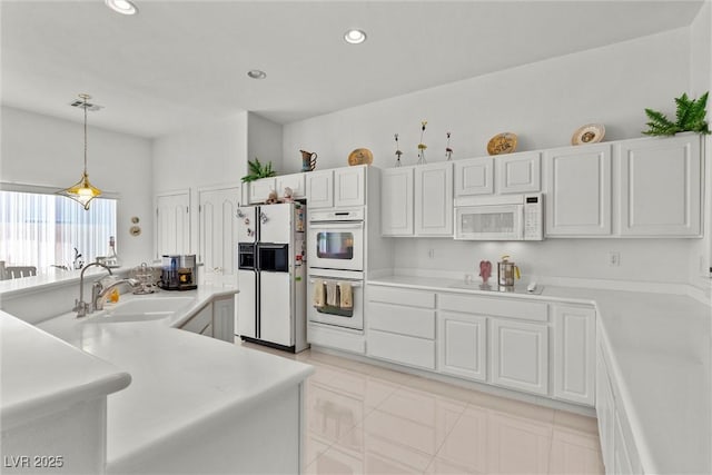 6141 Markleham Ave, Las Vegas, NV 89130 - kitchen featuring white appliances, light countertops, hanging light fixtures, white cabinets, and recessed lighting