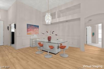 6141 Markleham Ave, Las Vegas, NV 89130 - game room with wood finished floors, a chandelier, a towering ceiling, and a decorative wall
