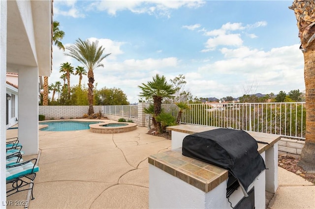 1933 Davina St, Henderson, NV 89074 - view of patio / terrace featuring a fenced backyard, exterior kitchen, a grill, and a pool with connected hot tub