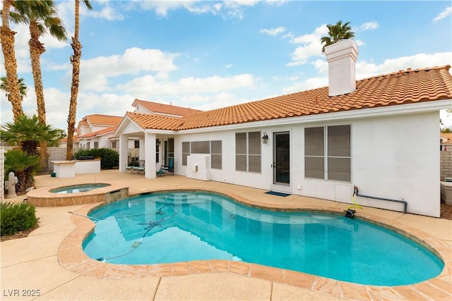 1933 Davina St, Henderson, NV 89074 - back of house with a tiled roof, a patio area, stucco siding, and a chimney