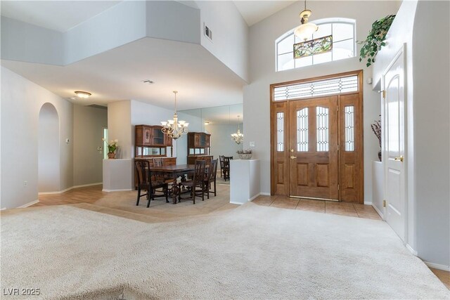 1933 Davina St, Henderson, NV 89074 - entryway featuring a chandelier, light carpet, arched walkways, healthy amount of natural light, and a high ceiling