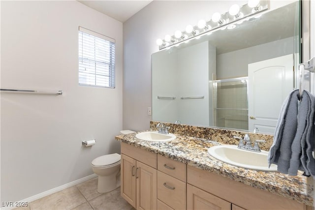 1933 Davina St, Henderson, NV 89074 - bathroom with a shower stall, baseboards, tile patterned floors, toilet, and double vanity