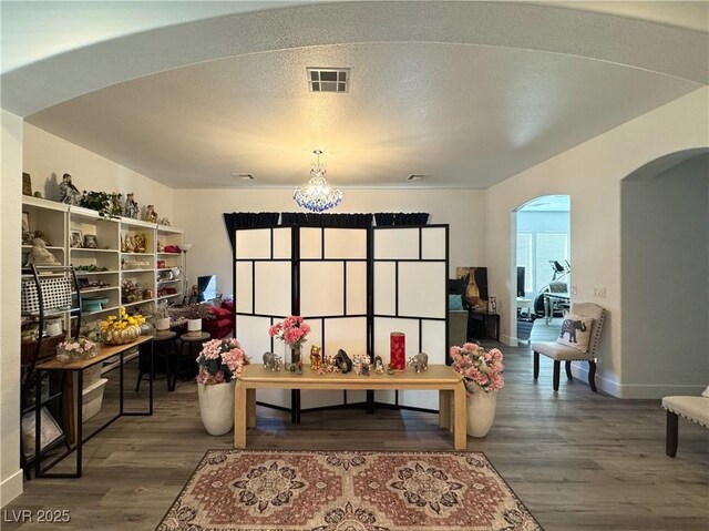 5422 Nestled Moon Ct, Las Vegas, NV 89131 - playroom featuring arched walkways, wood finished floors, a chandelier, and baseboards