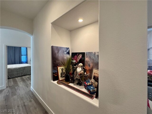 5422 Nestled Moon Ct, Las Vegas, NV 89131 - corridor with arched walkways, wood finished floors, and baseboards