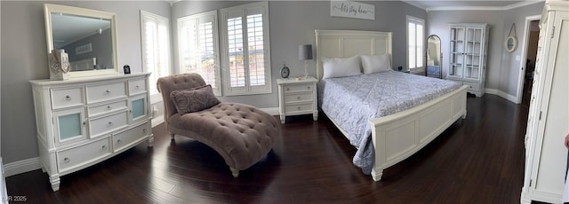 bedroom featuring multiple windows, ornamental molding, baseboards, and dark wood-type flooring
