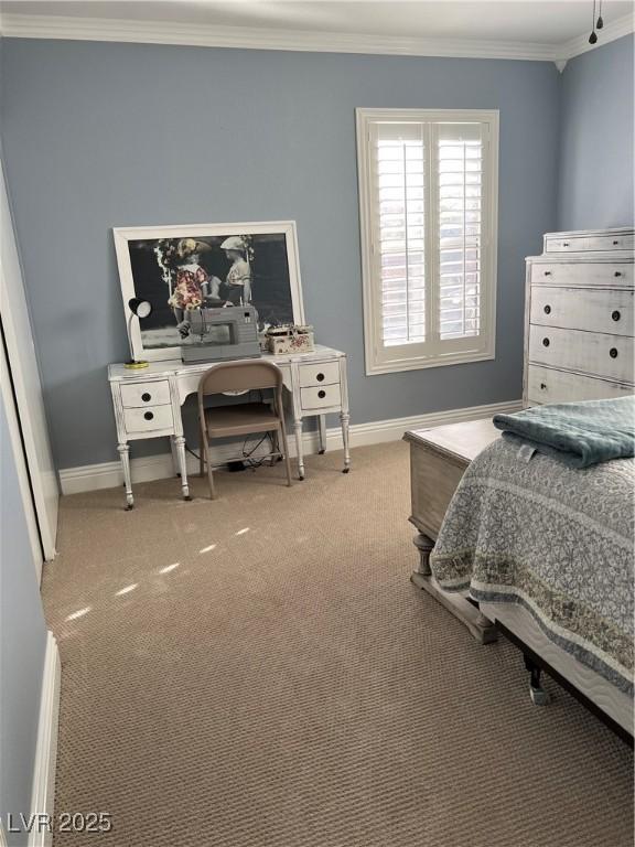 bedroom with ornamental molding, baseboards, and carpet