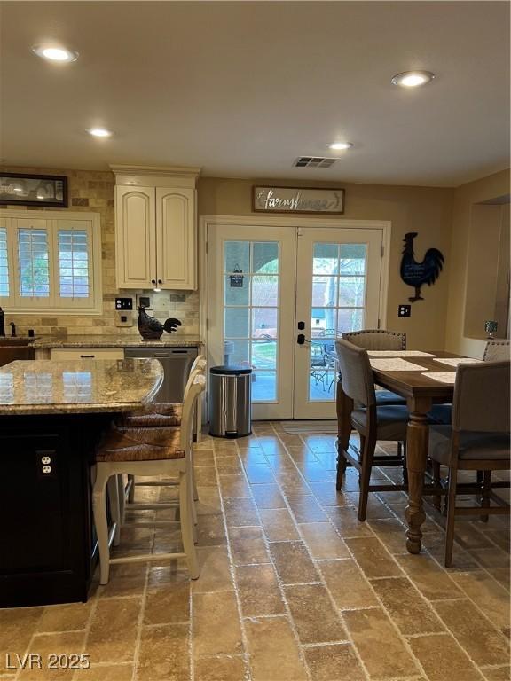 dining space with french doors, recessed lighting, and brick patterned flooring