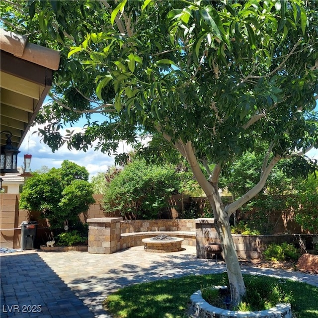 view of yard featuring an outdoor fire pit, a patio, and fence