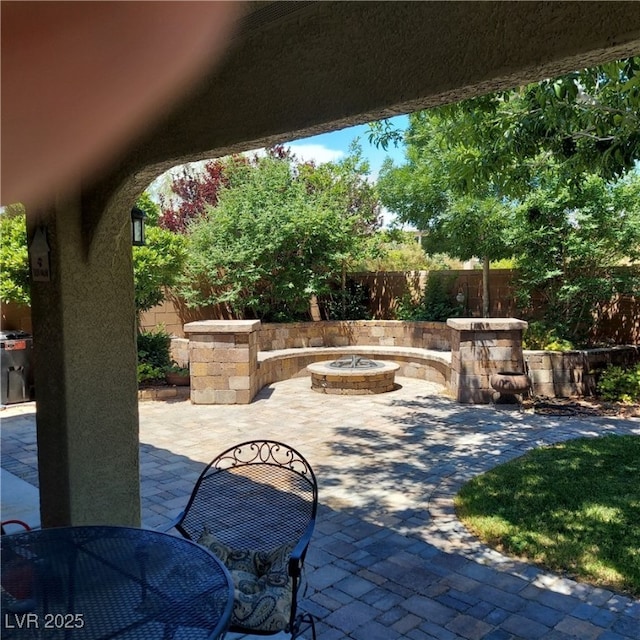 view of patio / terrace with an outdoor fire pit and a fenced backyard